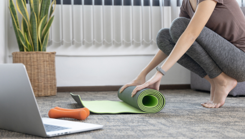 exercising at home with yoga mat and weights