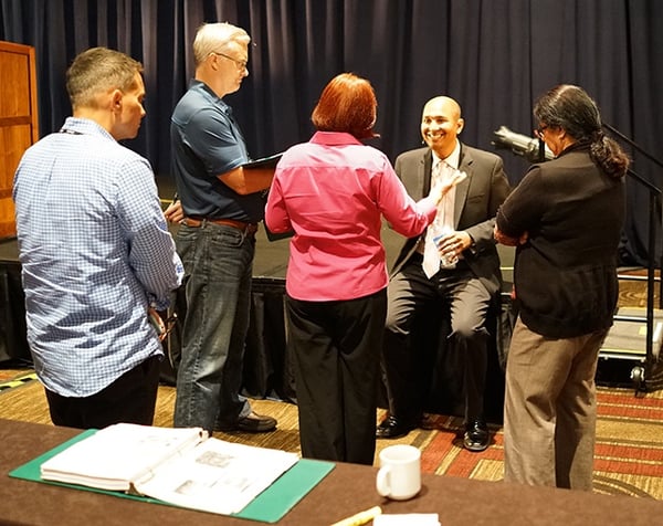 Picture of Dr. Raj talking with attendees after his lecture at the internal medicine board review course 
