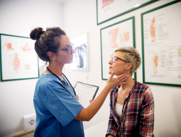 female doctor giving an exam to a female patient, physician burnout prevention 